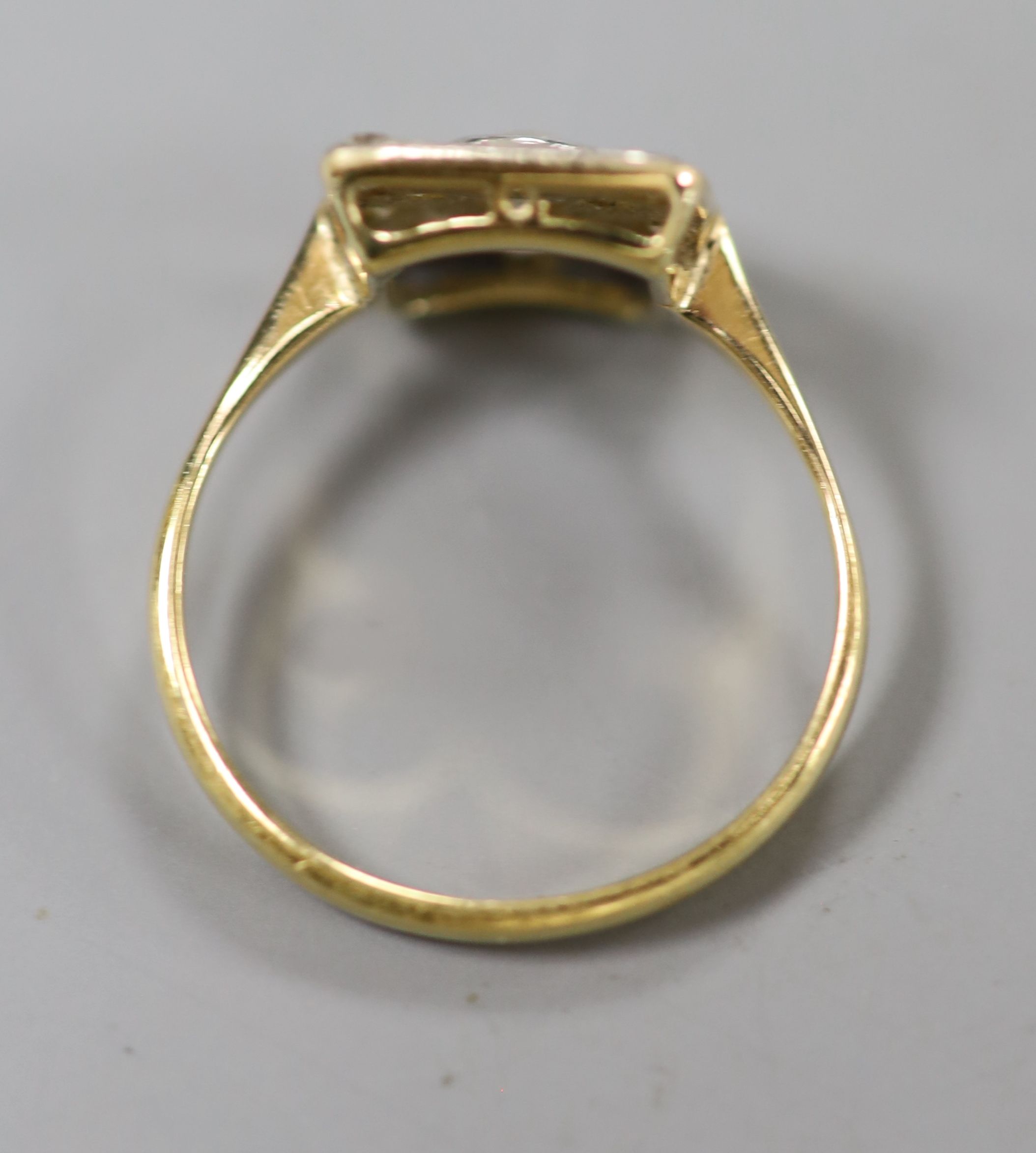 A 1940s yellow metal and diamond set square cluster ring, size M, gross 2.8 grams.